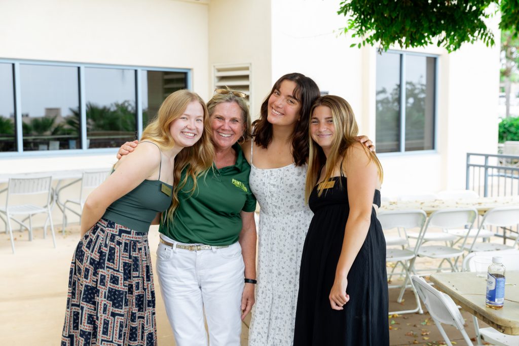 a group of 4 women standing next to each other