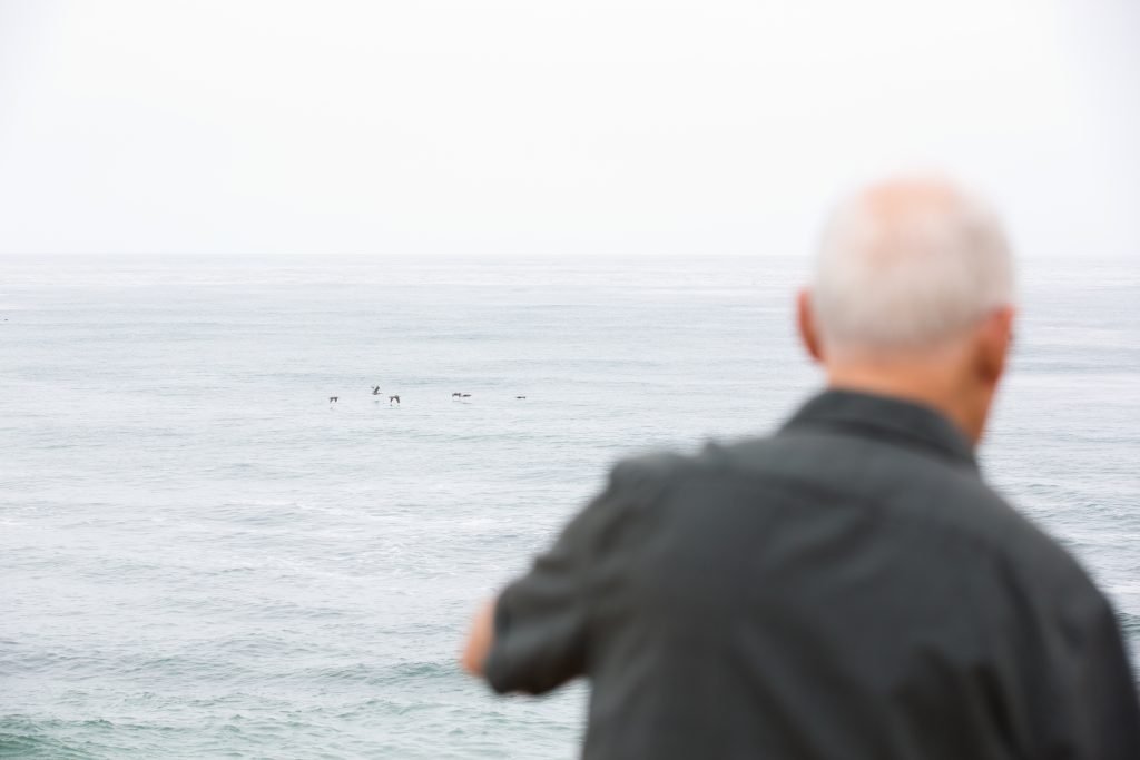 a man looking at the ocean