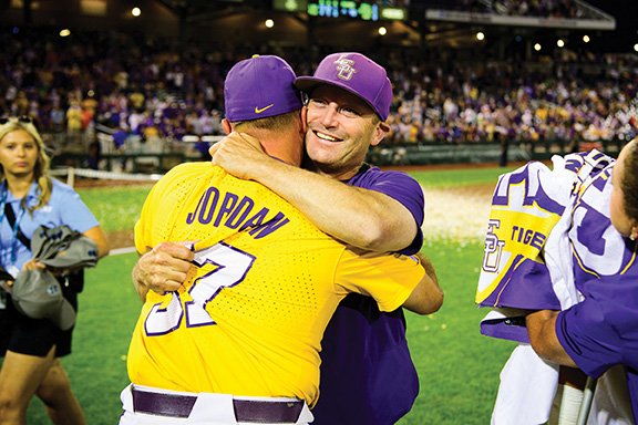 a man hugging another baseball player