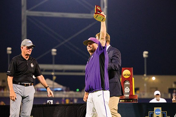 a man holding a trophy