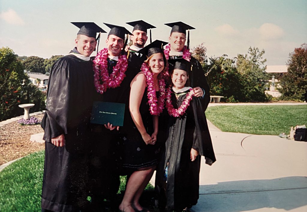 Cordell and her classmates post graduation in their caps, gowns, and leis in 2001.