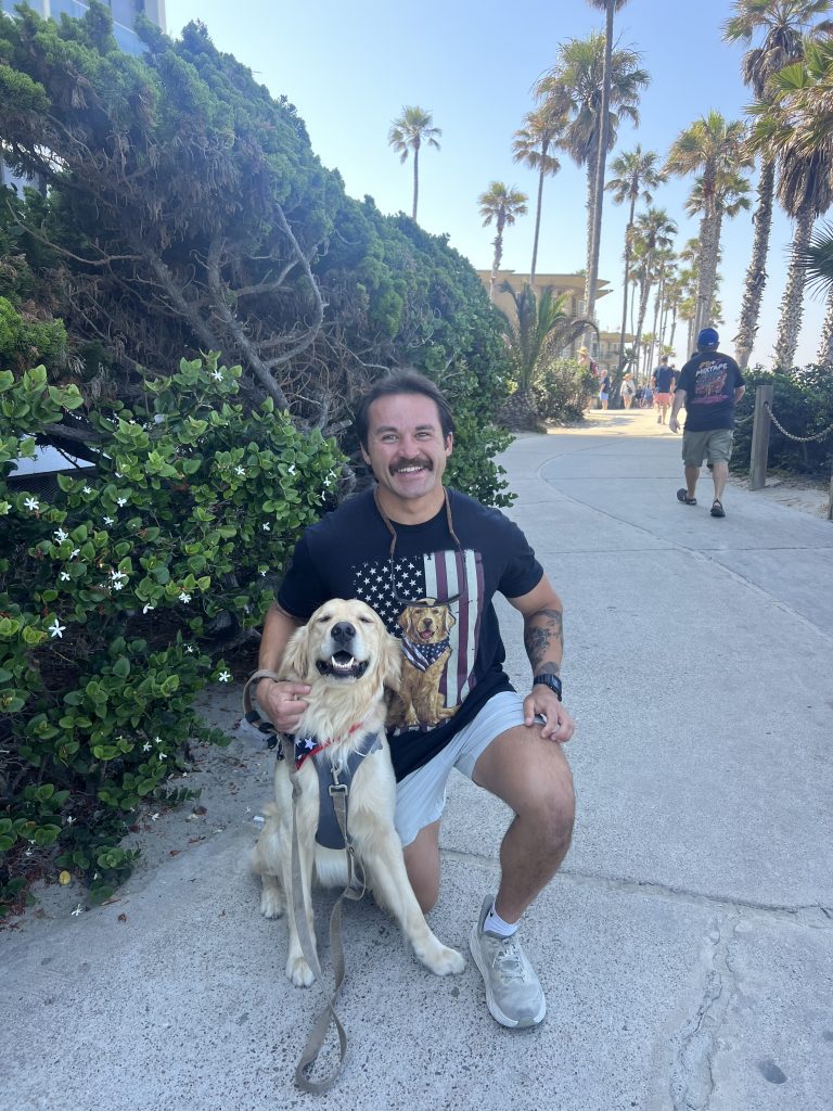 a man kneeing with his dog
