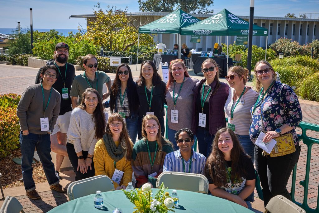 A PLNU alumni reunion group gathers for a photo at Homecoming.