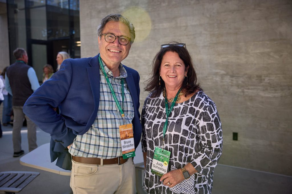 Two PLNU alums reconnect outside the Science complex at Homecoming.