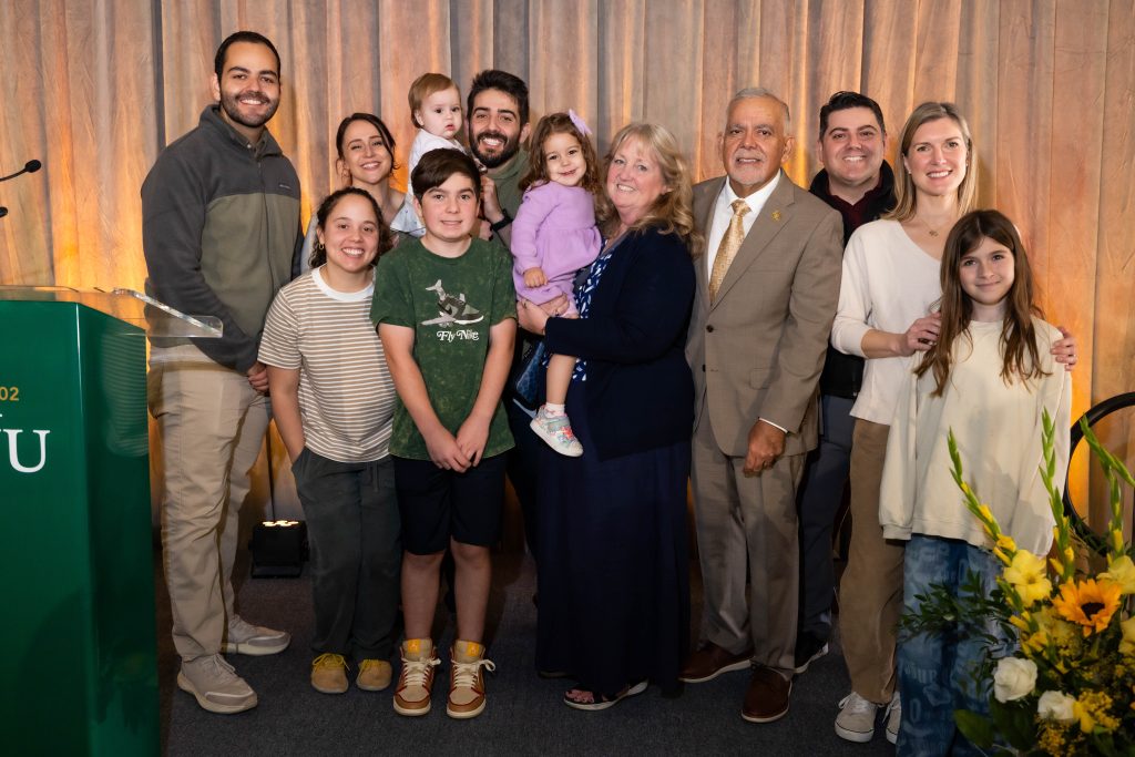 Rene Bravo's family gathers for a photo during the Homecoming awardee ceremony. 