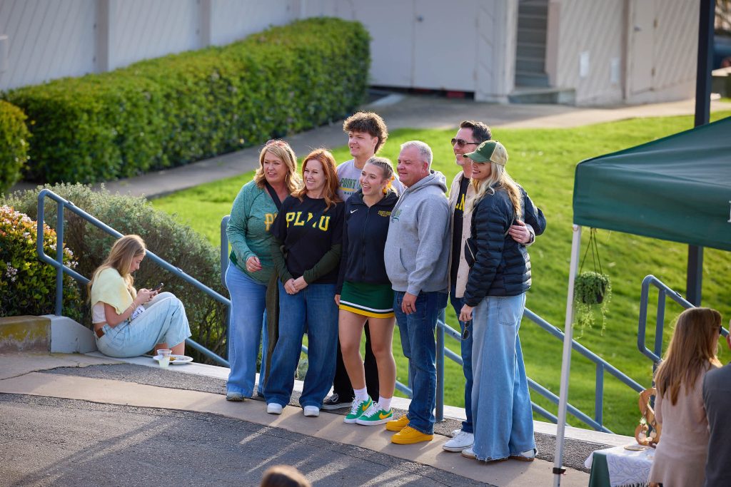 A family of many generations gather for a group photo outside PLNU Caf Lane.