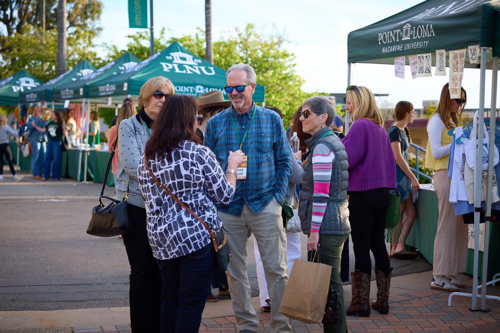 Alums reconnect and catch up at the campus mall at PLNU Homecoming.