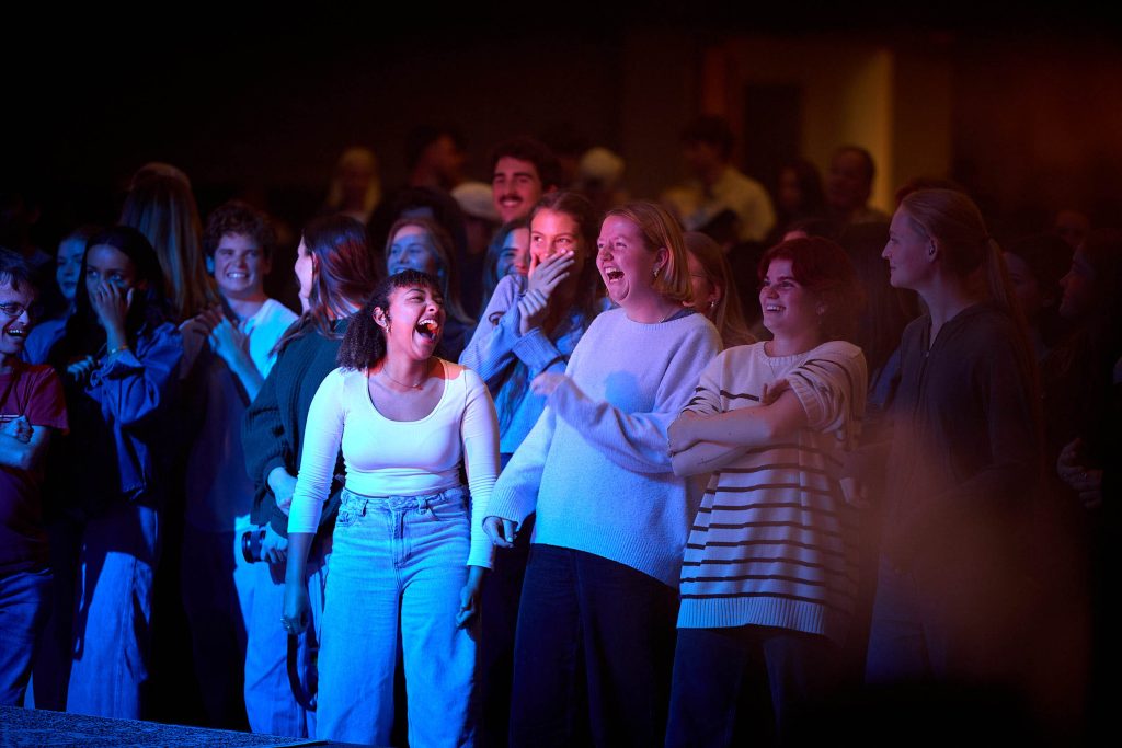 PLNU students dance and laugh during a concert.