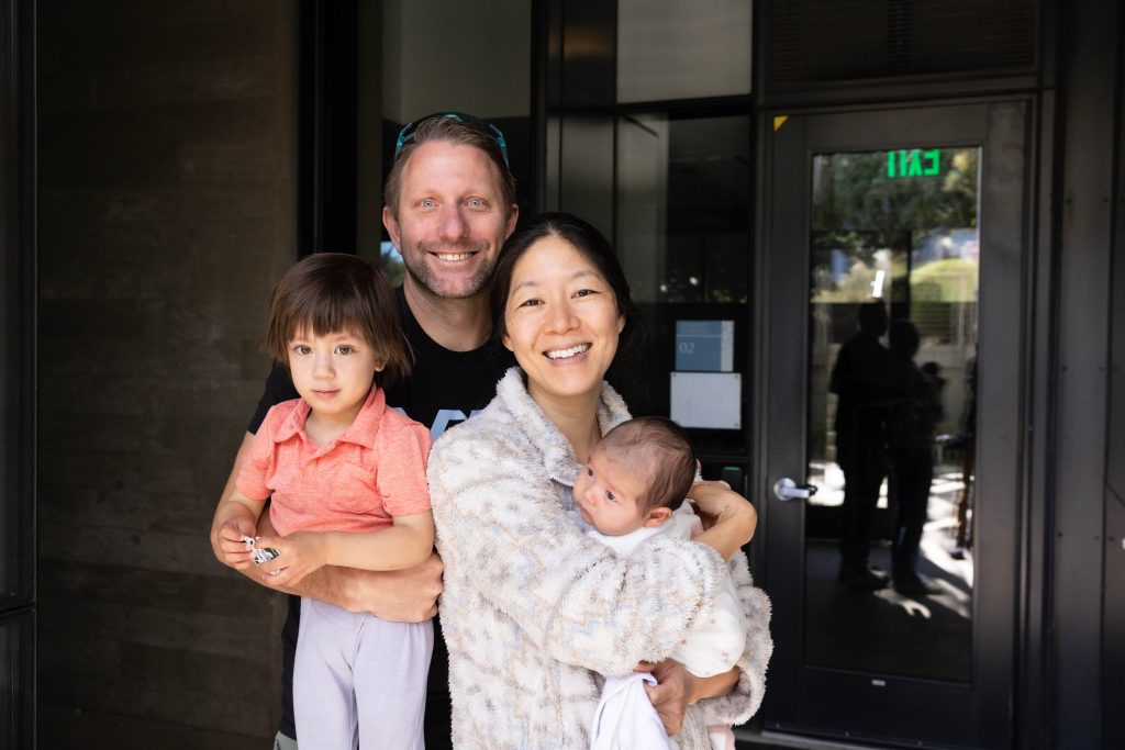 A family with two young children visit PLNU for Homecoming together.
