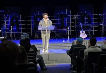 Applied Health Major Mark Challita Trusts God With Leadership Roles A man standing and speaking on the stage