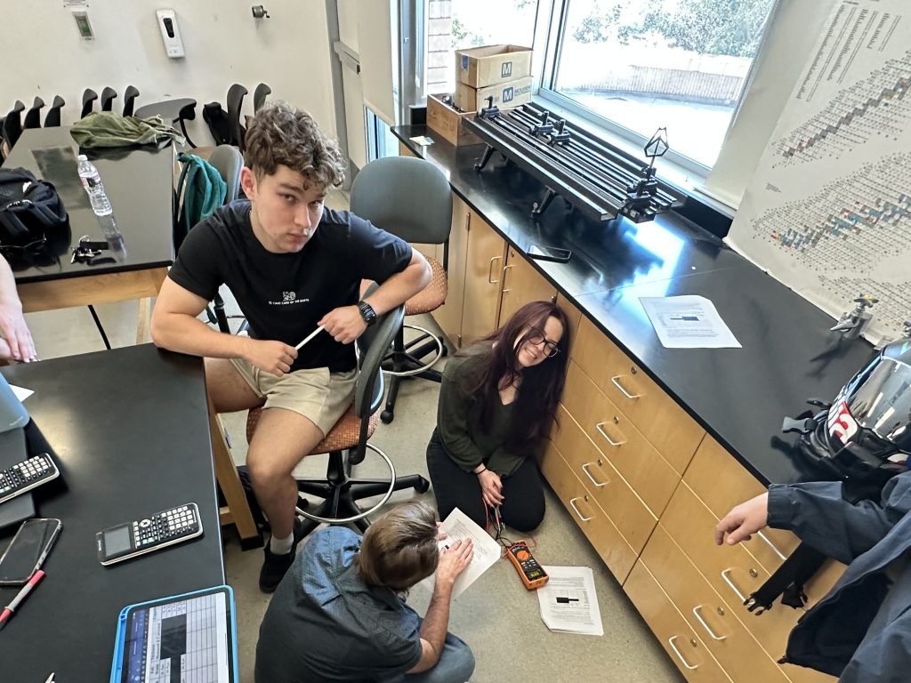 A PLNU student with friends in a lab.