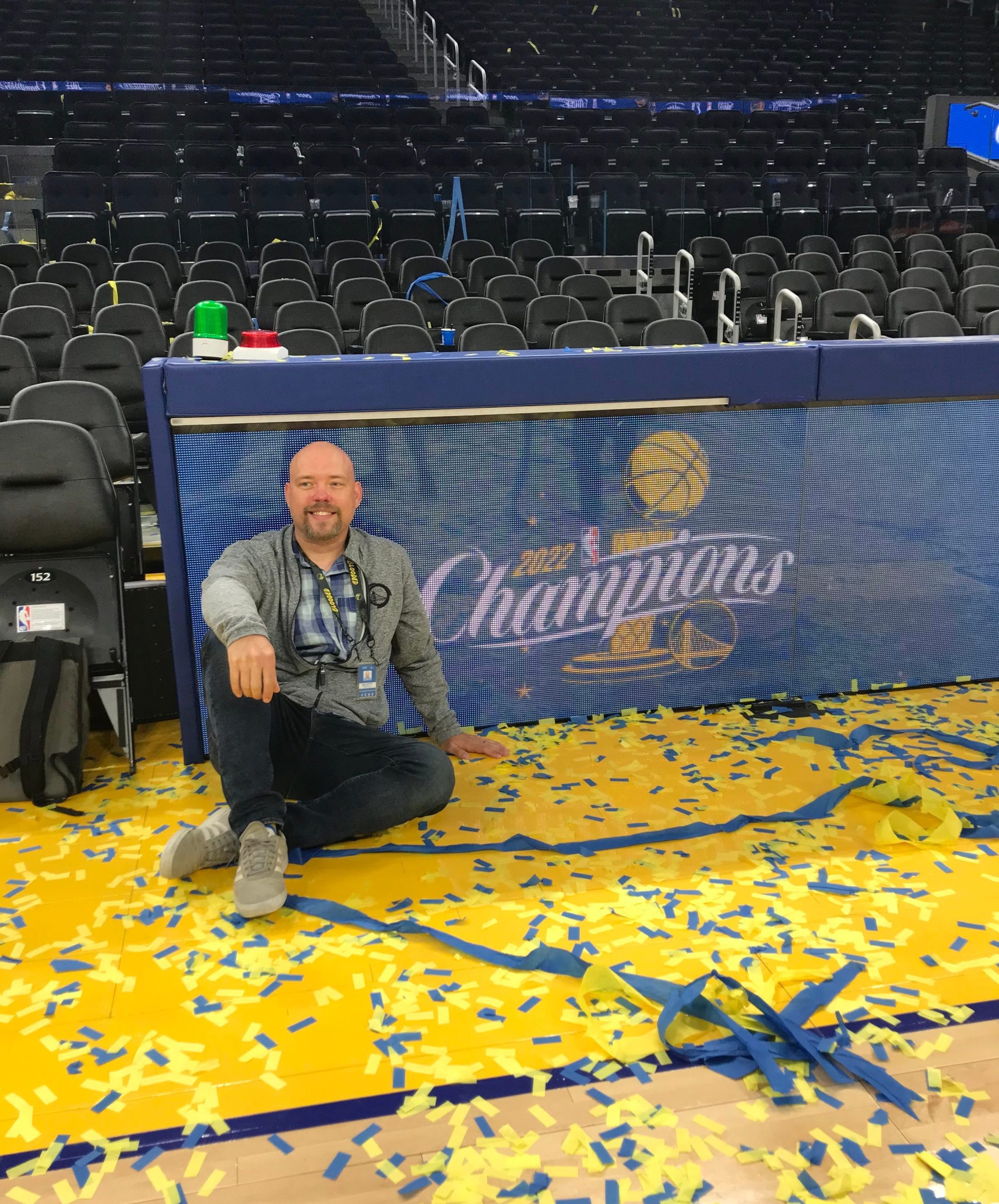 Heitman sits in front of the Golden State Warriors' 2022 champions banner. 
