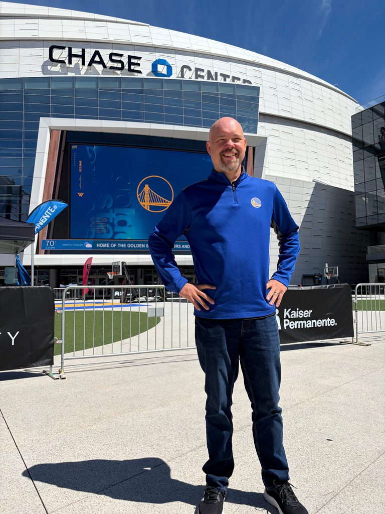 Heitman standing outside in front of the Chase Center stadium. 